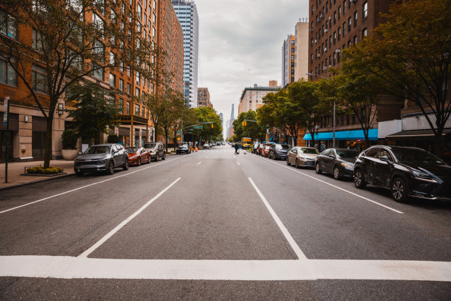 Manhattan street view with parked cars and apartment buildings