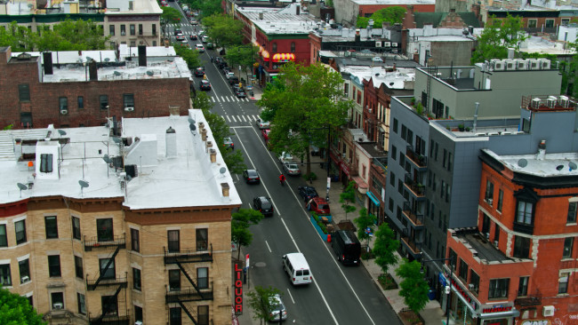 New York City on a hazy day in summer, following traffic on Nostrand Avenue in Crown Heights, Brooklyn.