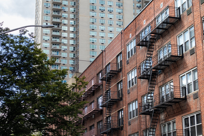 A row of modern residential skyscrapers with balconies and a blue sky on the Upper East Side of New York City