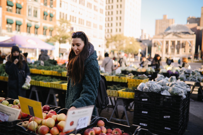 Woman going for grocery shopping in an open street market in New York, NYC.