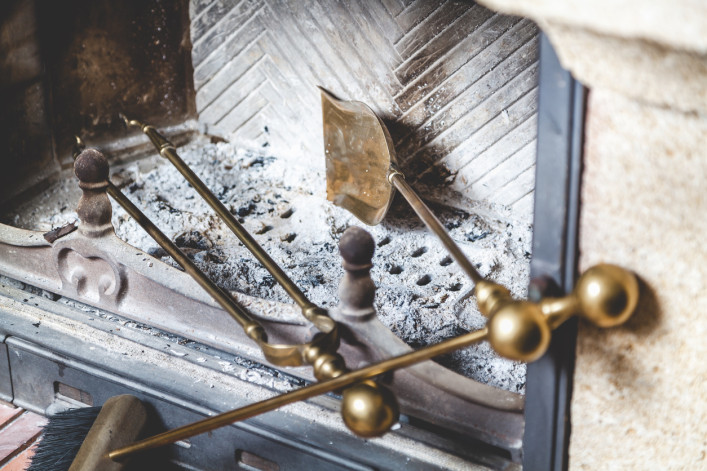 fireplace with cleaning tools