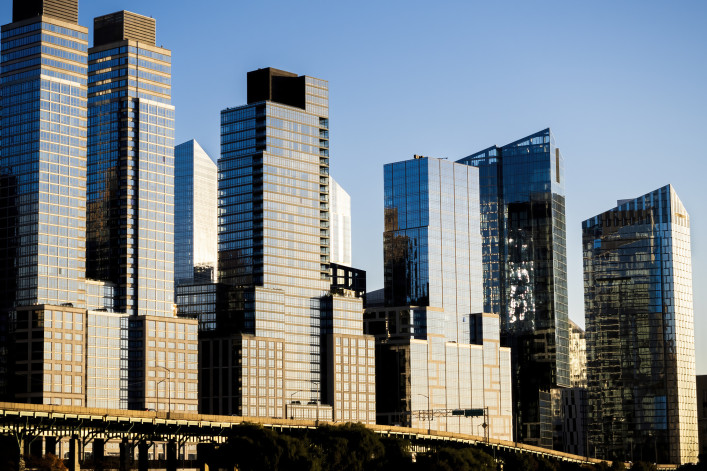 Glimmering steel and glass apartment buildings along the West Side Highway, south of the Henry Hudson Parkway, far west of Manhattan, New York City, on a sunny fall day. Skyline, NYC.