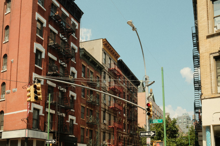 Red brick buildings with fire escapes in NYC