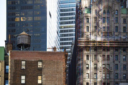 Close-up view of some buildings and skyscrapers during sunset. Downtown Manhattan, New York City, United States of America. - stock photo