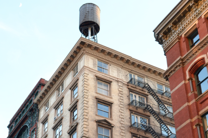 UES old building with water tower blue sky