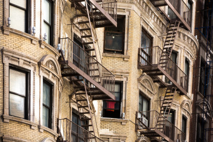 Old apartment building with fire escapes, Manhattan, New York City