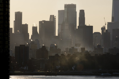 Steam emitting from building rooftops during winter in New York City.