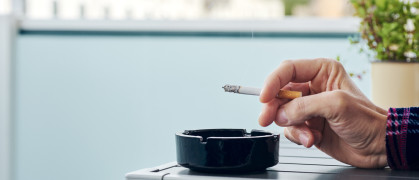 A hand holds a cigarette.