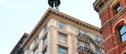 UES old building with water tower blue sky