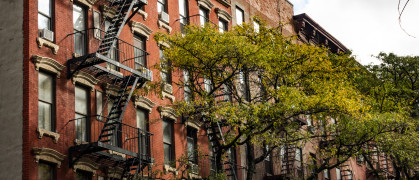 Close-up view of New York City style apartment buildings with emergency stairs along Mott Street in Chinatown neighborhood of Manhattan, New York, United States.