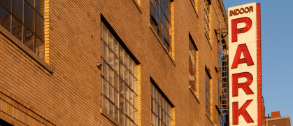 Building garage parking sign during sunset on the west side of Manhattan, New York City.