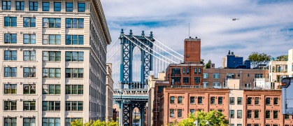 Dumbo is a vibrant Brooklyn neighborhood known for its artistic scene, offering spectacular views of the iconic Steel Manhattan Bridge. stock photo