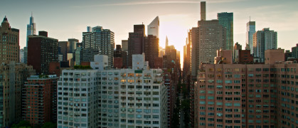 Drone shot of New York City on a summer evening, taken from over the East River and looking towards Midtown Manhattan.