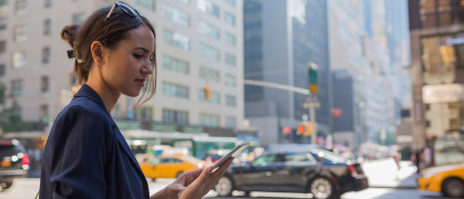 woman looking at her phone on a NYC street