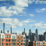 The NYC skyline as seen behind new apartment buildings.